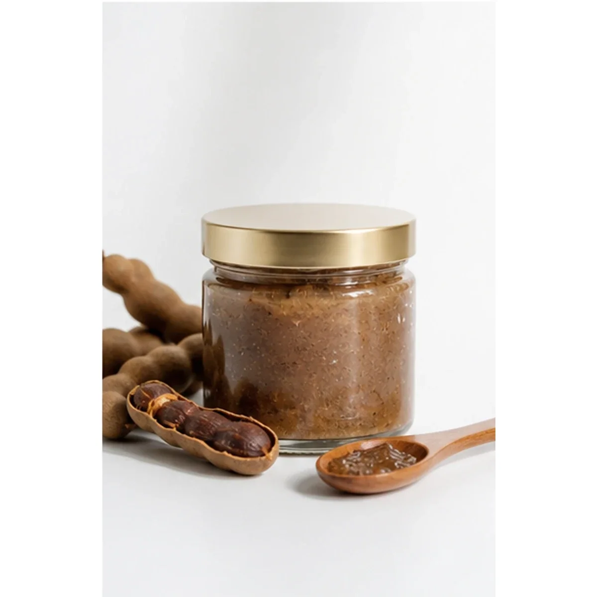 Jar of Serey Skin Tamarind Body Polish with tamarind and a wooden spoon